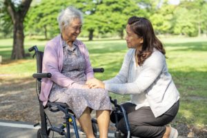 Helping an elderly woman in a wheelchair, highlighting the idea of the role reversal when caring for aging parents