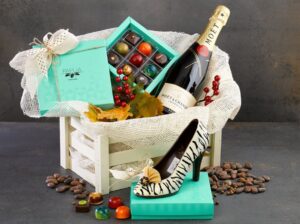 An elaborate example of gift boxes for older women, that includes chocolate, wine, and even a shoe